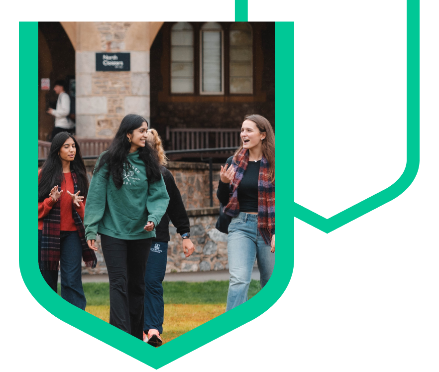 Students outside on campus, walking while chatting.